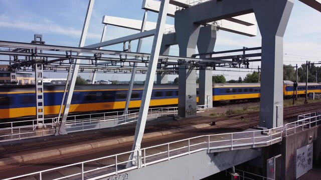 Railway bridge over river Vecht in Holland in the city of Weesp, Dutch yellow train