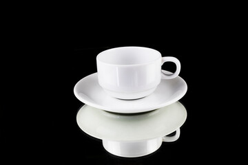 White coffee cup reflection with a saucer, on black background with clipping path, ready to cut out, copy space for graphic design.