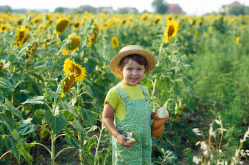 Happy little girl with bread in the field