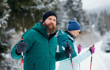 Mature couple cross country skiing outdoors in winter nature, Tatra mountains Slovakia.