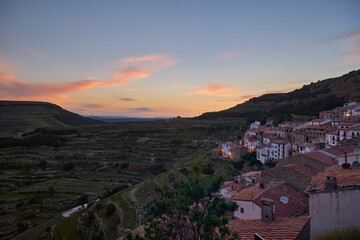 Colorful sunset in a valley with the village to one side