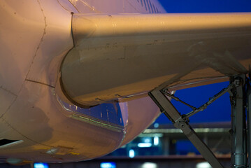 Close-up of wing fuselage transition of airplane at Zürich Airport on a cloudy late summer evening. Photo taken September 9th, 2021, Zurich, Switzerland.