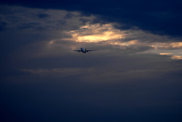 Airplane in the sky at late summer evening with dramatic sky in the background. Photo taken September 9th, 2021, Zurich, Switzerland.