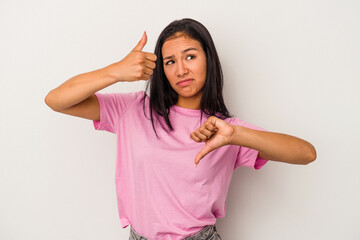 Young latin woman isolated on white background  showing thumbs up and thumbs down, difficult choose concept