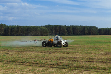 Tractor sprays liquid chemical fertilizers