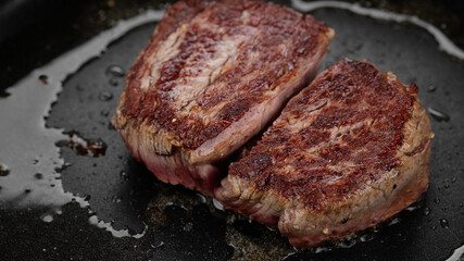 Cooking juicy meat steak in pan, close up. Roasting filet mignon