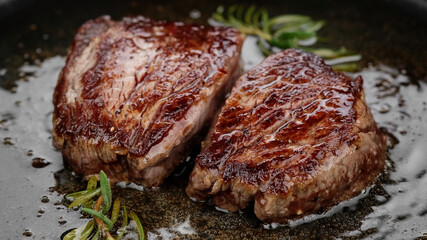 Cooking juicy meat steak in pan, close up. Roasting filet mignon