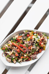 traditional greek Ktapodi octopus salad bowl on Athens restaurant table