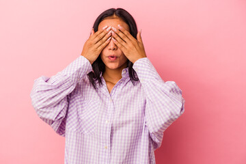 Young latin woman isolated on pink background  afraid covering eyes with hands.