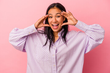 Young latin woman isolated on pink background  receiving a pleasant surprise, excited and raising hands.