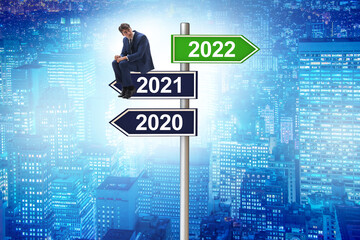 Businessman on the signpost from 2021 to 2022