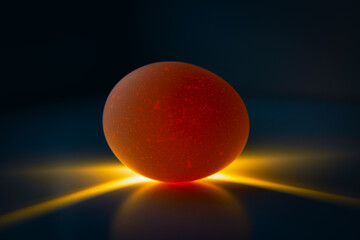 Photo of an egg lit from behind that looks like a planet. Concept of the universe and life