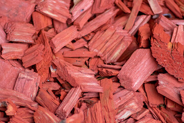 Shredded red wood chips fragments as red woodpath with timber shavings and recycled and renewable...