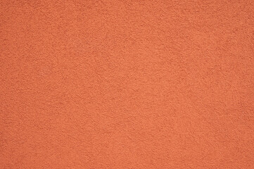 Fototapeta premium red colored concrete wall background texture with soft lighting