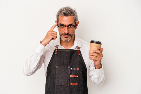 Middle Age Store Clerk Holding A Take Away Coffee Isolated On White Background  Pointing Temple With Finger, Thinking, Focused On A Task.