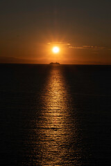 Obraz premium a beautiful sunrise sun reflects on the sea, during a warm summer morning