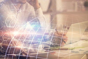 Double exposure of man and woman working together and technology theme world map drawing hologram. International business tech concept. Computer background.