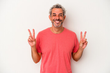 Naklejka premium Middle age caucasian man isolated on white background showing victory sign and smiling broadly.