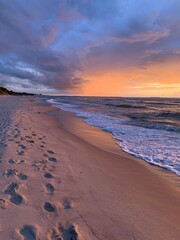 Fantastic orange and purple sunset at the sandy beach, paradise, evening sea background