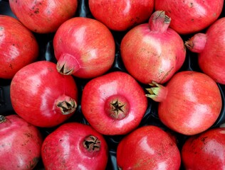 Freshly picked pomegranates. Background and texture, top view and full frame.