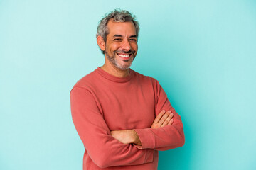 Middle age caucasian man isolated on blue background  who feels confident, crossing arms with...