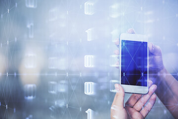 Double exposure of technology sketch hologram and woman holding and using a mobile device.