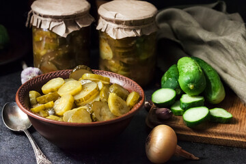 Pickled cucumber salad in a bowl and jars