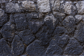 Very dark and old facade rusty pattern construction stone wall background