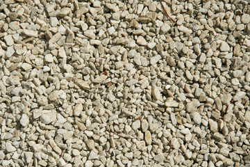 Natural colorful pebble stones background texture with copy space.