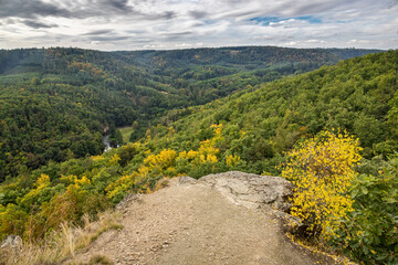 Fototapeta na wymiar Rocky viewpoint over river valley and colorful forests
