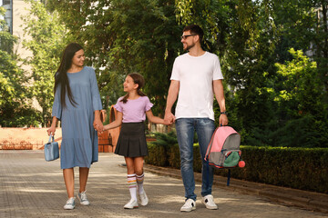 Fototapeta premium Parents taking their daughter to school in morning