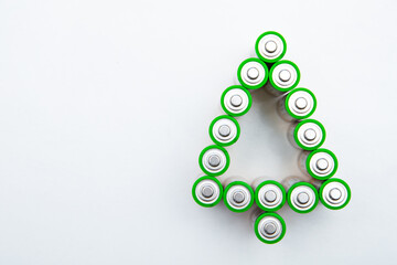 The batteries are in the shape of a Christmas tree on a white background. top view, flat lay, copy space, isolate