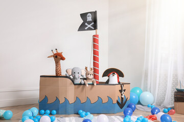 Child's room interior with pirate cardboard ship and toys