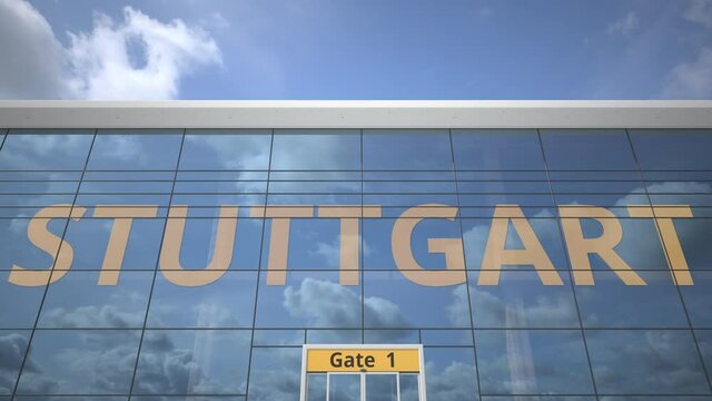 Commercial airplane reflecting in airport terminal with STUTTGART text