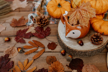 Autumn creative composition made of pumpkins, tea cup, dried leaves. Autumn, fall, halloween concept. Season background