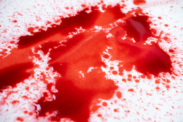 red ink splatter on white background
