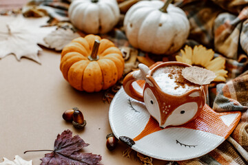 Autumn or Fall composition. Fall leaves, hot steaming cup of coffee on brown background. Mood, lifestyle, still life concept. Flat lay