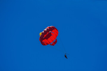 Red parachute in the sky
