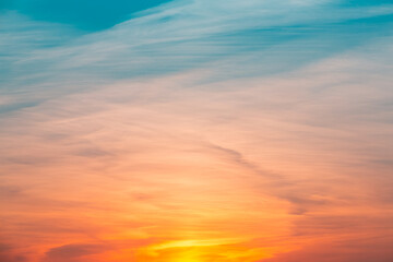 Obraz premium Pastel colored sunset sky. Abstract background with rays and lights. Stunning sunset at Gulf of Finland. Bright backlit sky and clouds. Incredible wallpaper. Blue, orange, pink backdrop