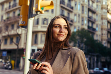 Appeased lady in the street holding her phone