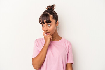 Young mixed race woman isolated on white background  relaxed thinking about something looking at a copy space.