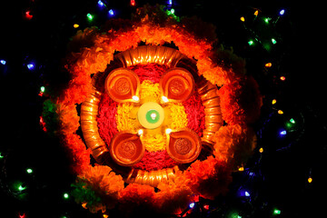 Diwali celebration Indian festival of lights Diya oil lamp and colors Rangoli decoration bright...
