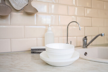 Naklejka na ściany i meble Eco friendly non-toxic cleaning dish soap with chamomile flowers, clean white plates 
