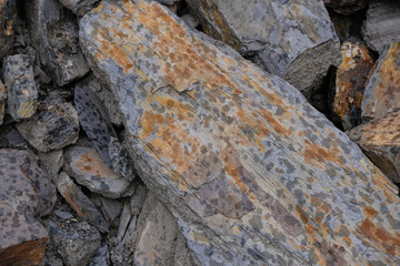  Slate stone monolith with rusty spots in the rain.  Natural stones for design in Germany.