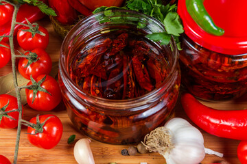 Dried tomatoes in oil in jar among the ingredients