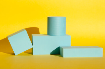minimalist abstract background. three-dimensional geometric podiums for goods on yellow background.