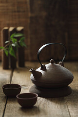 Tea ceremony, Chinese teapot on a wooden table.
