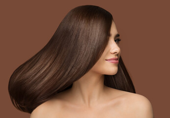 Hair Beauty Model. Brunette Woman with Long Straight Shiny Hairstyle over Dark Beige Background....