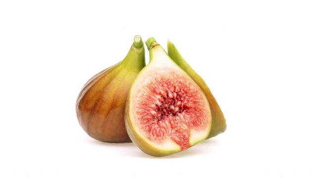 Three fresh fig halves isolated on white background.