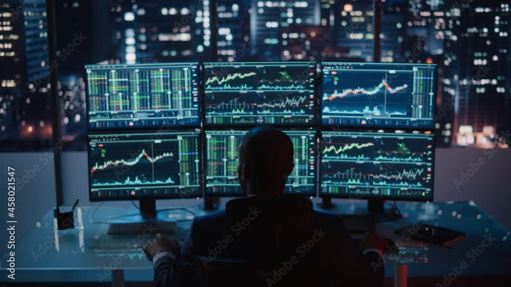 Poster Stock Market Broker Working on a Computer with Multi-Monitor Workstation with Real-Time Investment, Commodities and Foreign Exchange Charts. Businessman Works on Analysing Data in Office at Night.